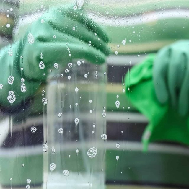 Clean glass window with soap bubbles, eco-friendly cleaning, streak-free shine, professional service.